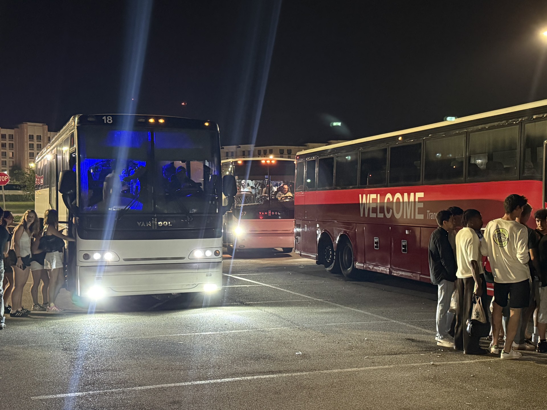 Welcome Transportation buses lined up at night