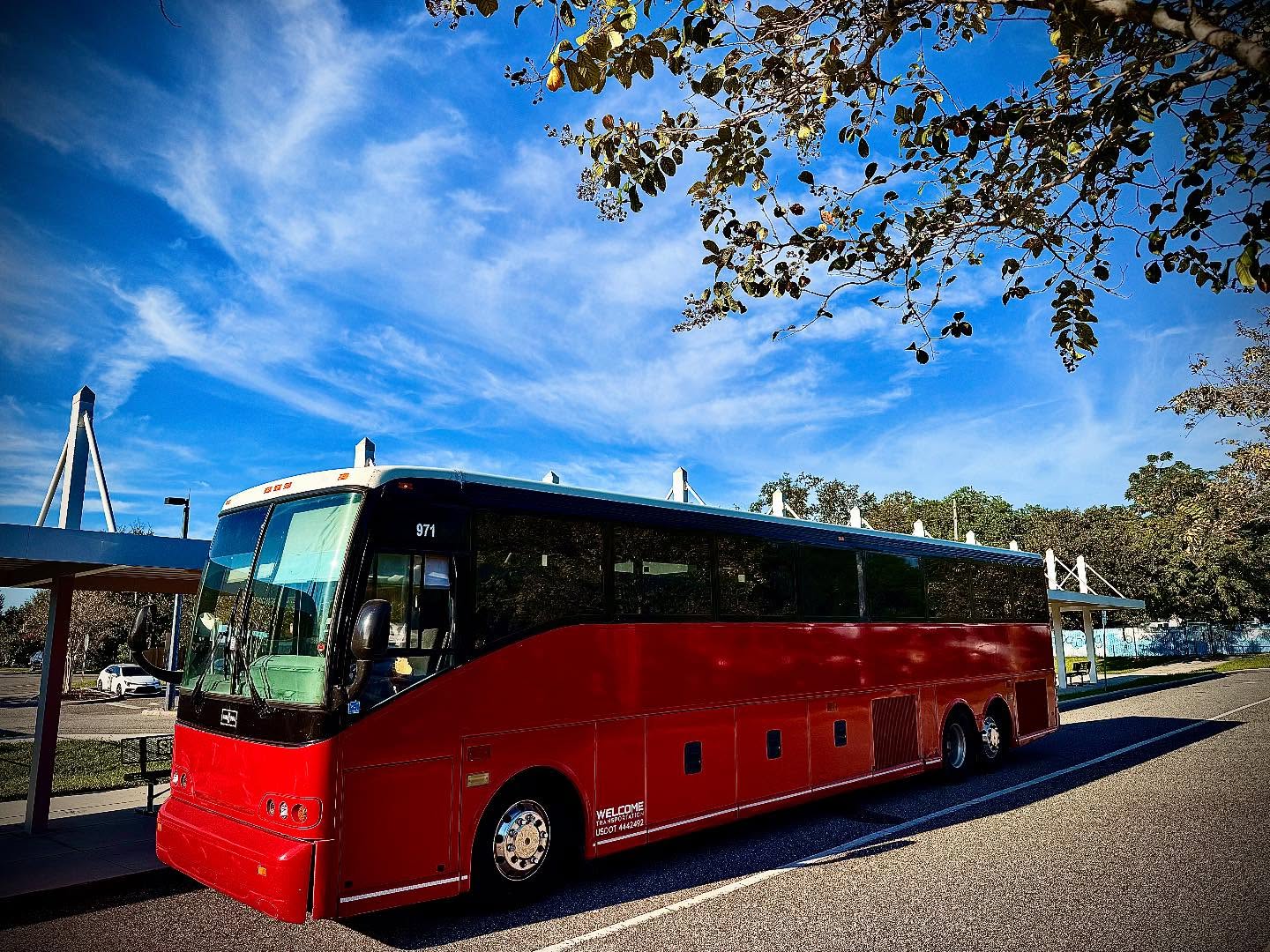 Welcome Transportation bus parked near a stadium bridge walkway