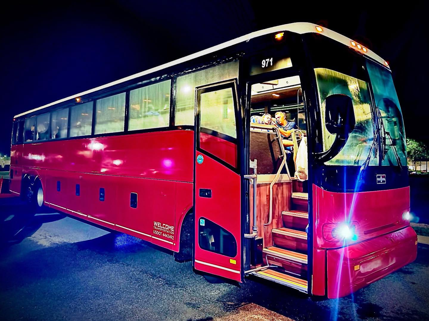 Welcome Transportation driver helping a passenger board at night