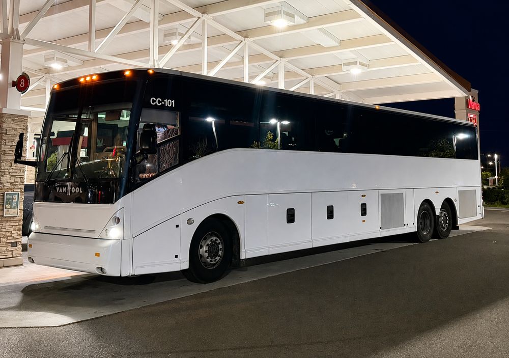 Welcome Transportation Bus 07, a white Van Hool motorcoach at night